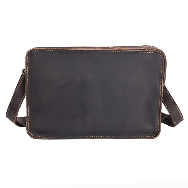 The man is holding a leather s - Interior Design Its recension och pris